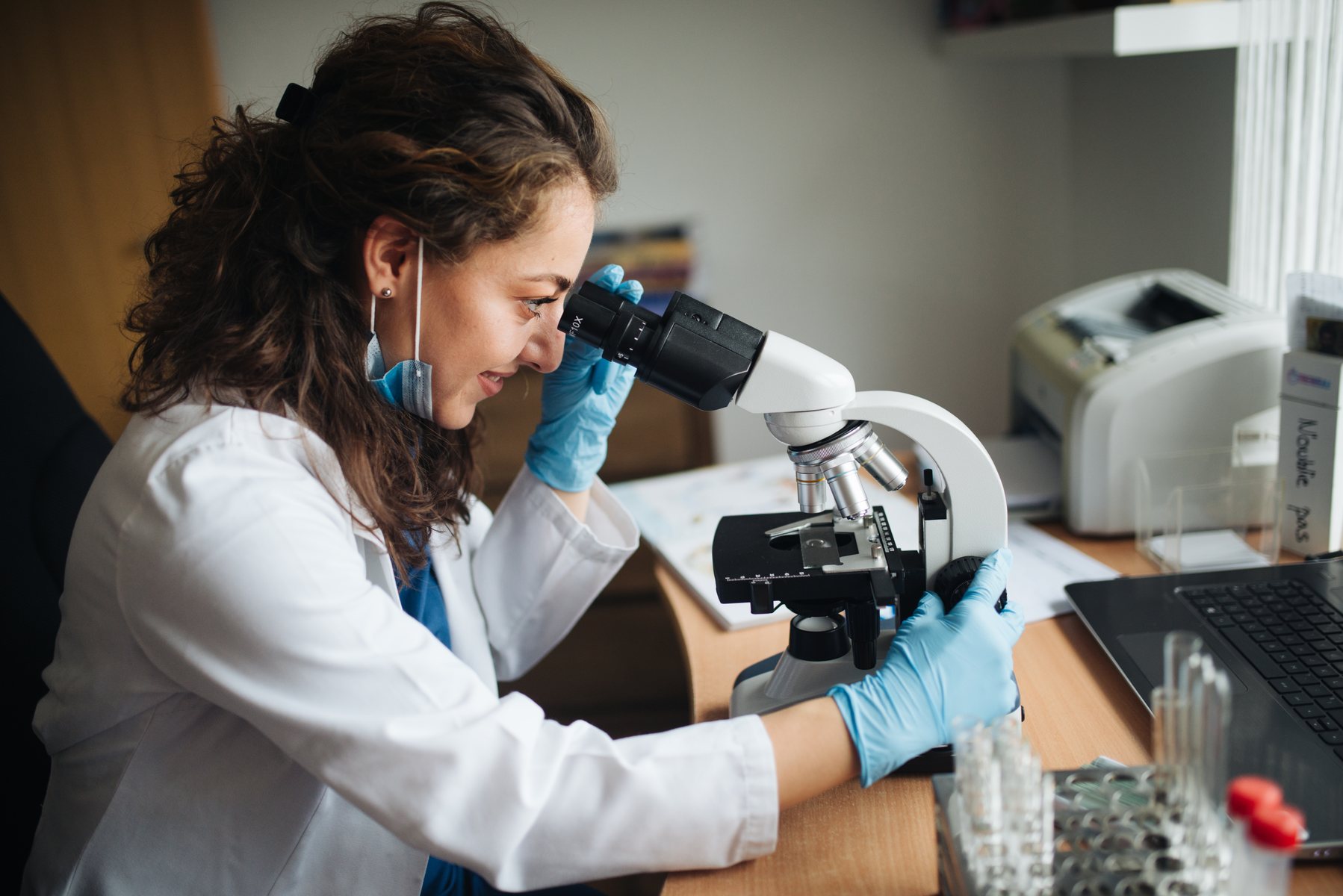Laboratory technician using microscope